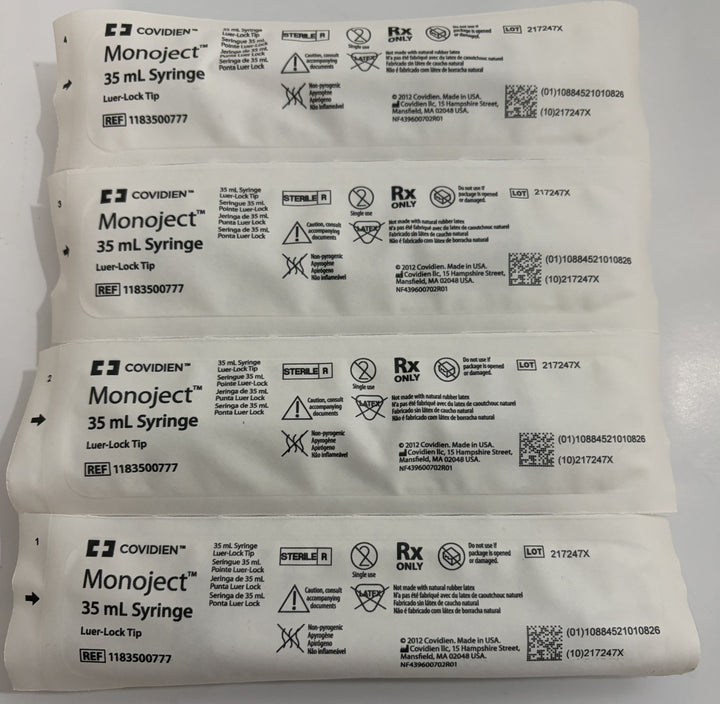 Four individually wrapped sterile 35 mL Luer Lock syringes by Covidien, showing packaging labels with usage instructions and medical symbols against a plain background.
