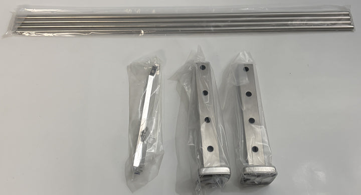 Set of ASI stainless steel hardware including two vertical support brackets, a smaller angled bracket, and a sealed package of wall mount rods for shelving installation.