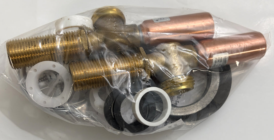 Set of brass and copper plumbing parts in clear plastic packaging on a white background