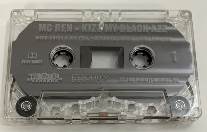 Close-up view of a vintage MC Ren audio cassette tape with clear plastic casing and gray label, featuring Priority Records and Ruthless Records branding.