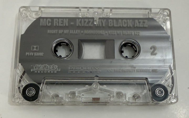 Pre-owned clear plastic audio cassette featuring "MC Ren Kizz My Black Azz" with Ruthless and Priority Records logos, capturing vintage music media style.