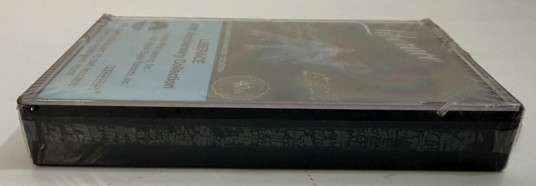 Sealed cassette tape in black plastic case featuring Liberace Live 40th Anniversary program, distributed by PFM/Silver Eagle Records, displayed on a neutral surface.