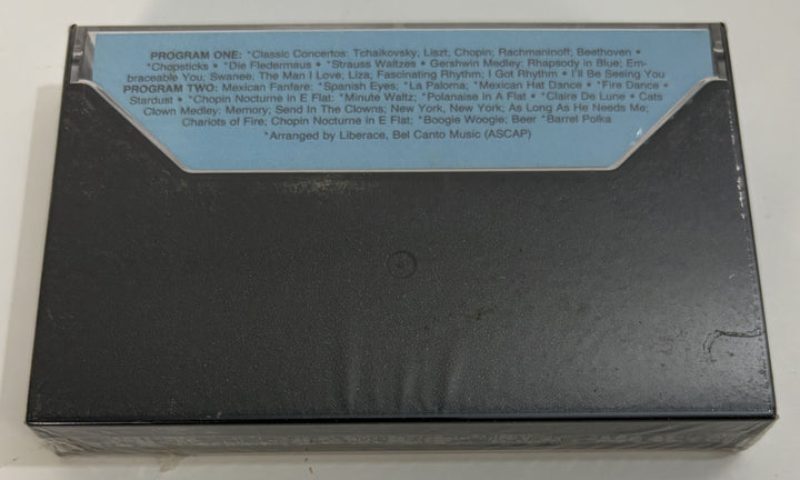 Rear view of a vintage Liberace Live anniversary cassette tape with a track listing label on the back, distributed by PFM/Silver Eagle Records.