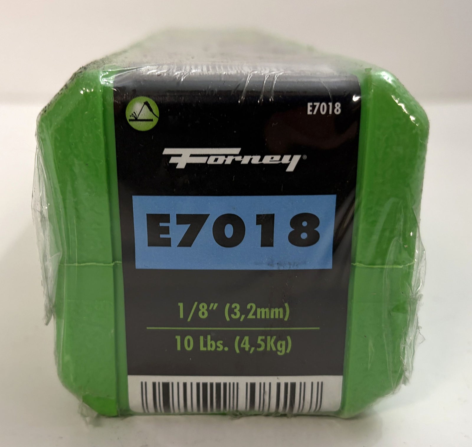 Compact green plastic container holding Forney welding electrodes labeled E7018, showing size and weight details on the front panel wrapped in clear plastic.