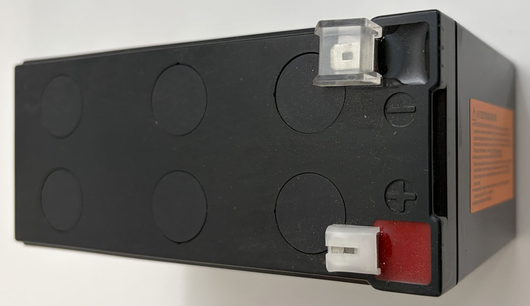 Black battery with visible terminals on a white background