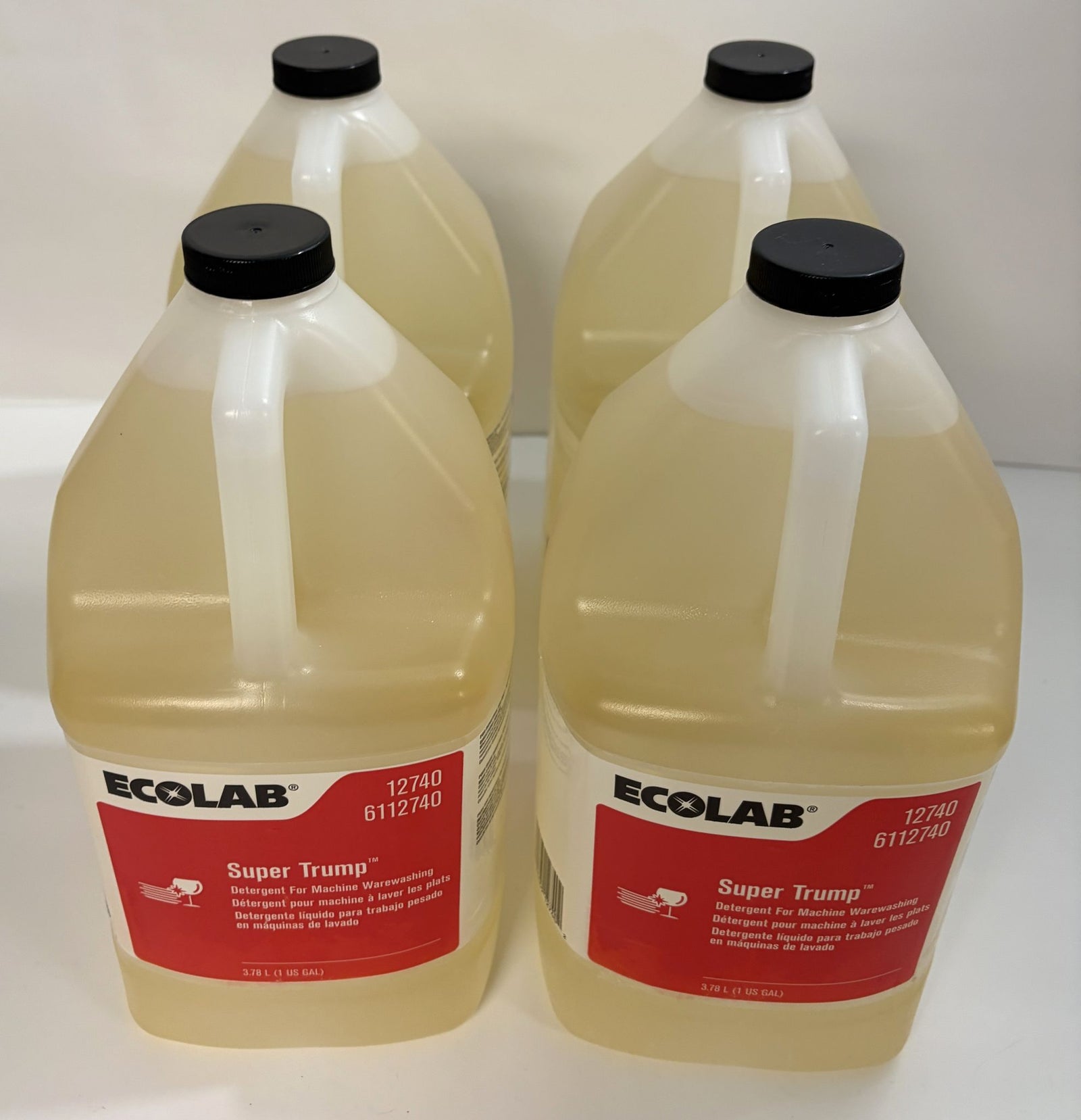 Four bottles of Ecolab Super Trump detergent on a white background
