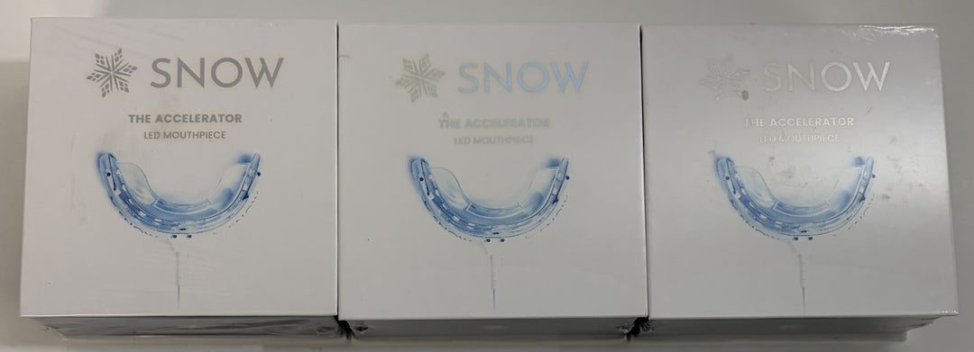 Three Snow brand LED mouthpiece devices for teeth whitening displayed in white packaging with blue mouthpiece illustrations on the front.