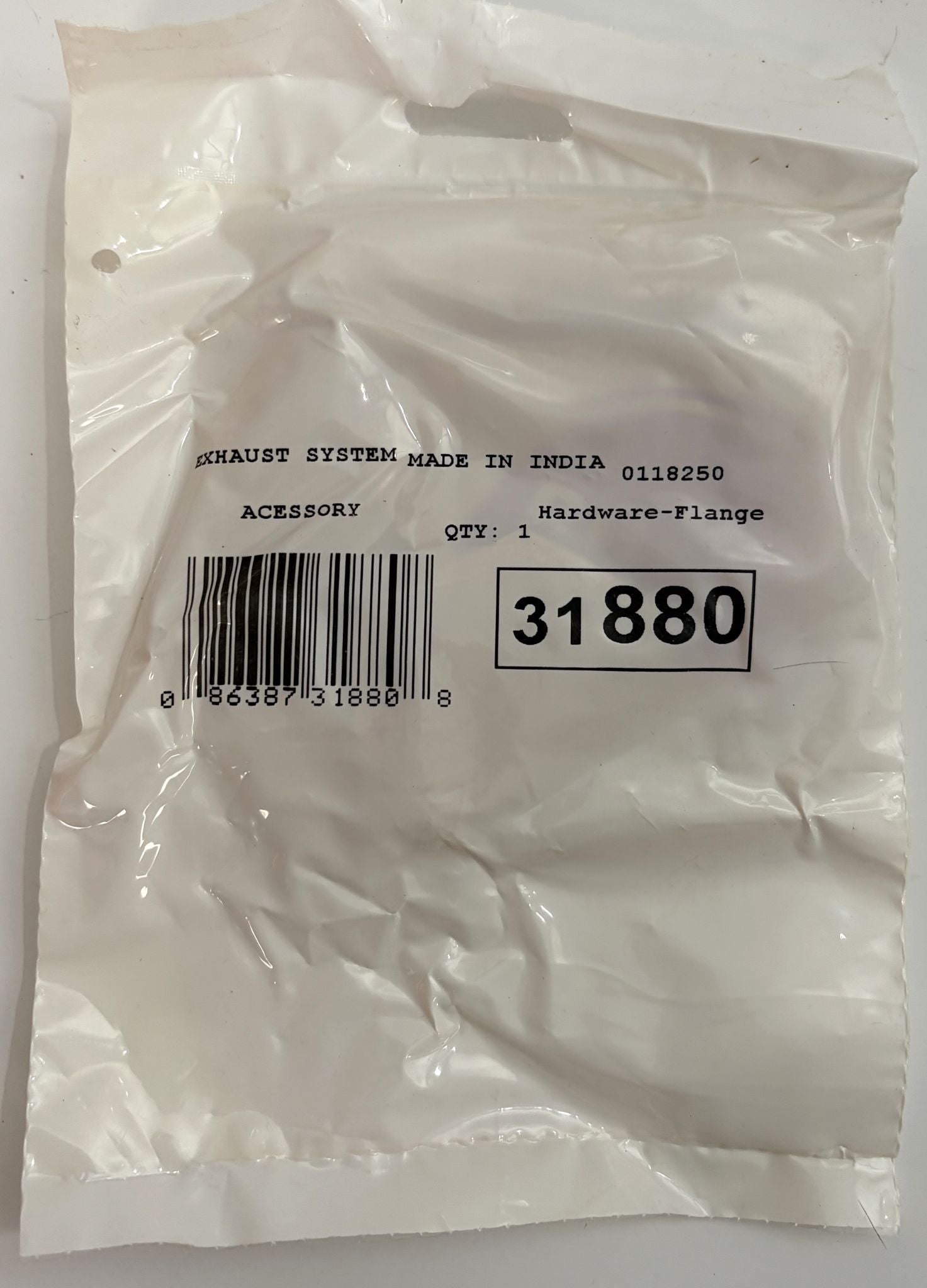 White plastic packaging bag labeled with part number 31880 for an exhaust hardware flange accessory, featuring a barcode and manufacturing details from India.