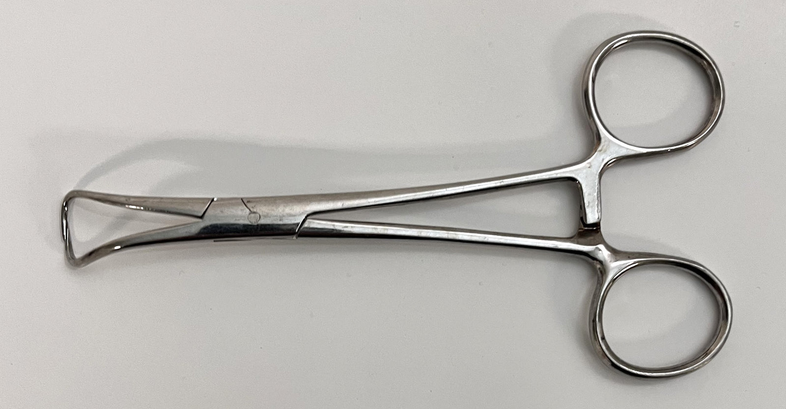 Close-up of Vantage V7-506 Backhaus Towel Clamp, 5.25" stainless steel with sharp, curved tips.