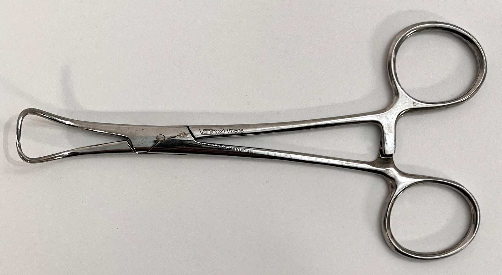 Close-up of Vantage V7-506 Backhaus Towel Clamp, 5.25" stainless steel with sharp, curved tips.