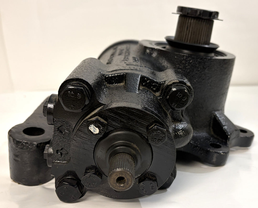 Black metal steering gear component with visible mounting holes and a gear shaft, shown on a white surface, branded Sheppard and designed for industrial use.