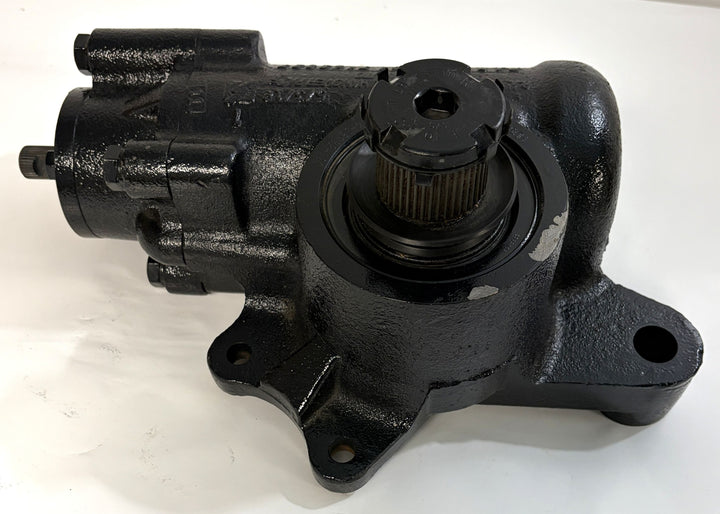 Black Sheppard steering gear component with mounting holes and a central gear shaft, displayed on a clean white surface for industrial and automotive use.