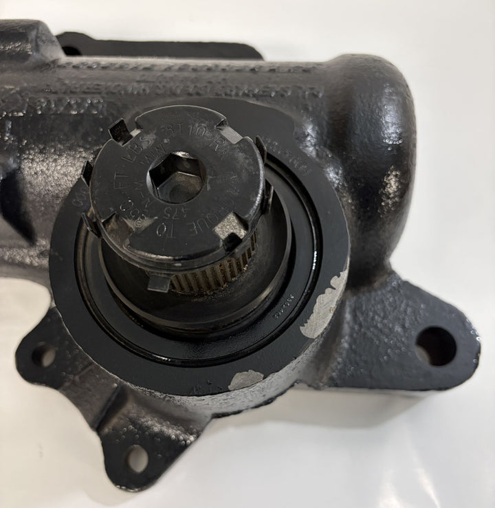 Close-up view of a black cast metal Sheppard steering gear component showing the splined central shaft and mounting points, part of industrial automotive equipment.