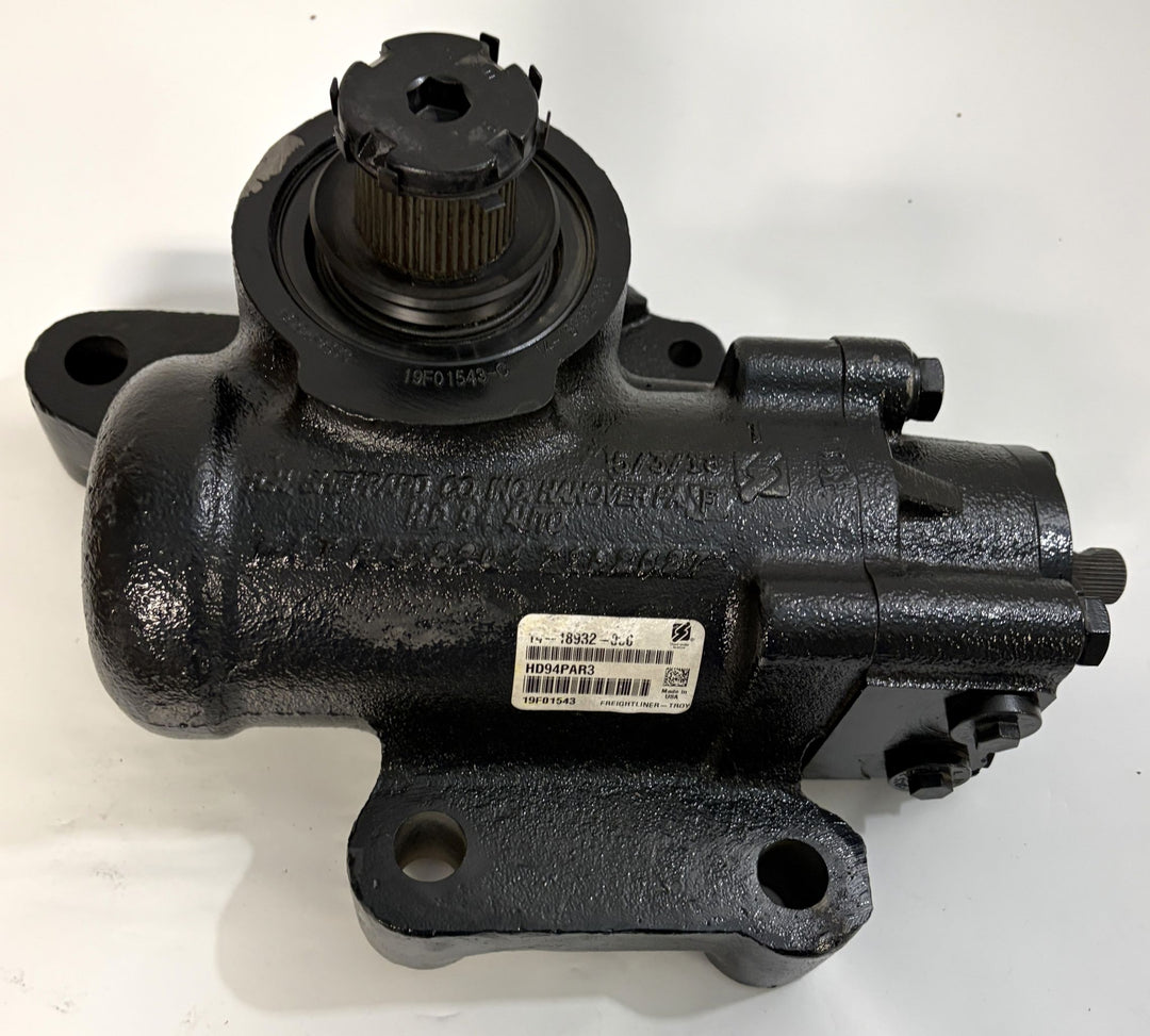 Black metal Sheppard steering gear component with mounting holes and a central gear shaft, designed for automotive use, shown against a plain white background.