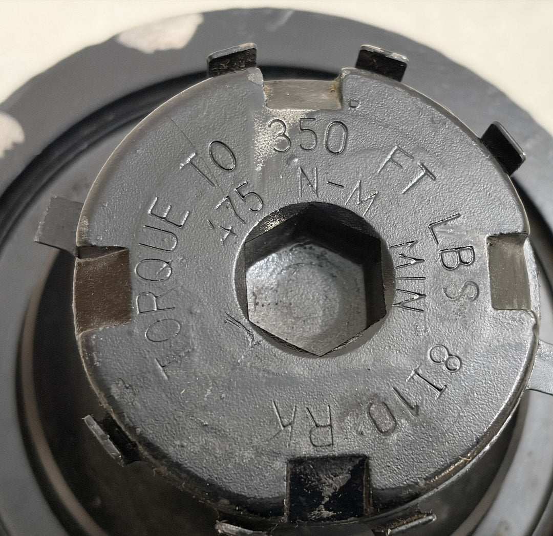 Close-up of a black metal steering gear component by Sheppard showing torque specifications engraved on the surface against a neutral background.