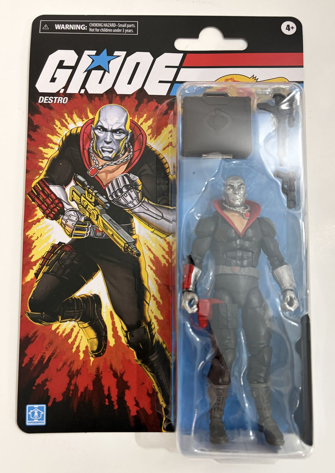 G.I. Joe Destro action figure in packaging with character illustration on the back