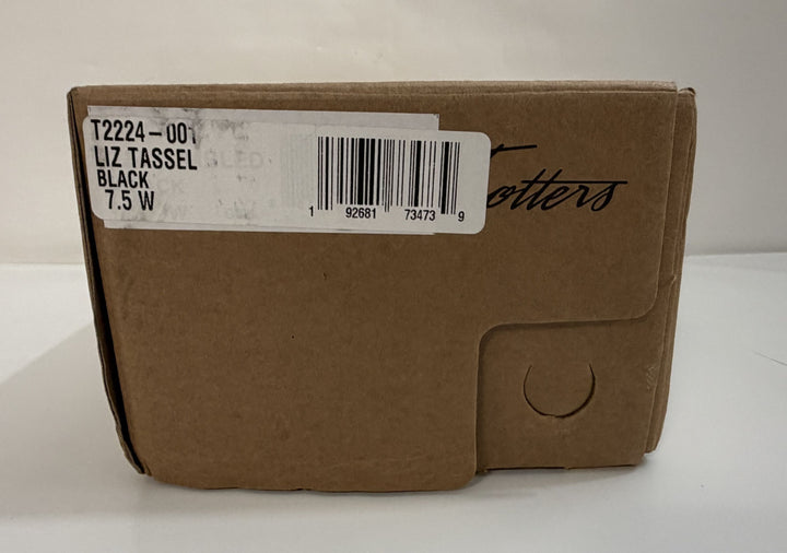 Brown cardboard shoebox with a label indicating Trotters black Liz Tassel loafers in women&