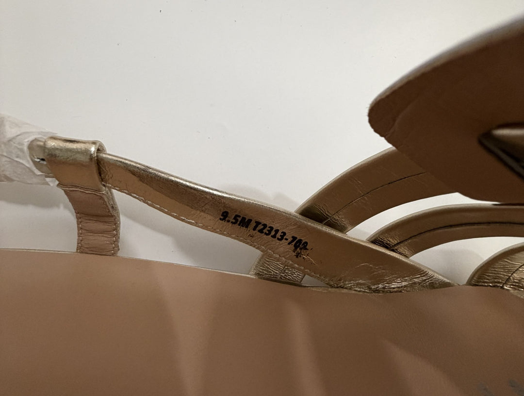 Close-up of a sandal with a strap and visible brand name on a white background