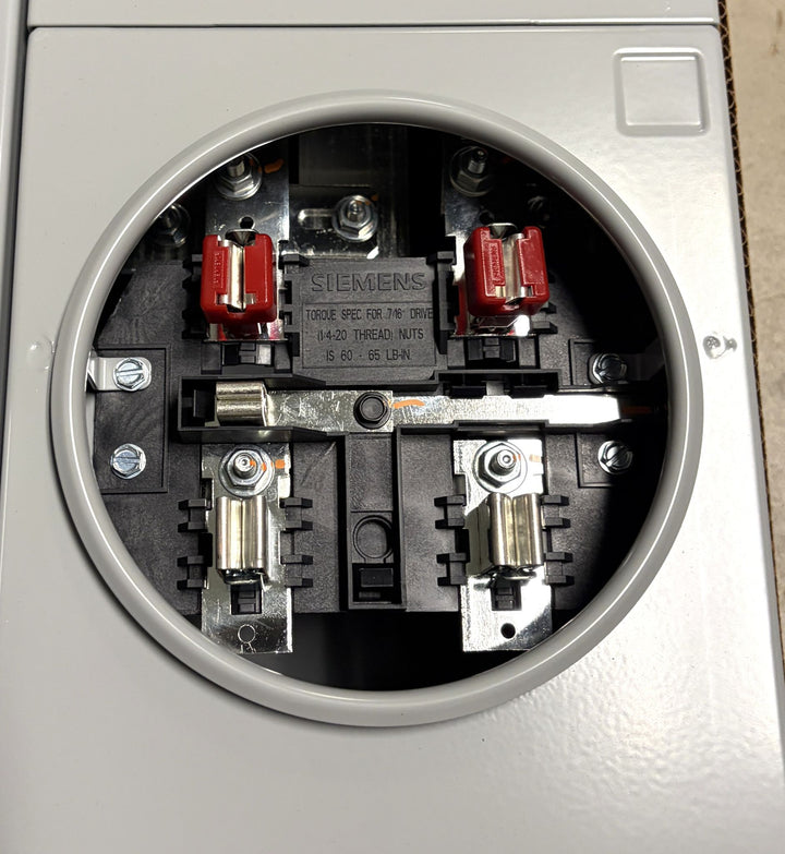 Interior view of a Siemens electrical meter socket with metal contacts, screws, and connection points visible inside a circular gray enclosure, designed for industrial or commercial electrical use.
