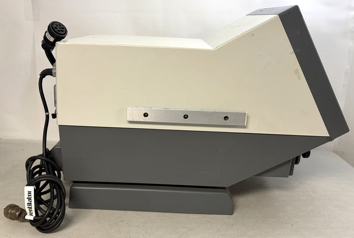 Side view of a Philips Respironics medical device core unit for parts or repair featuring a blank screen, attached cables, and a gray and white plastic casing.