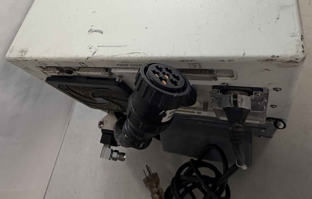 White rectangular medical device core unit with visible scuff marks, multiple power and data ports, and attached black cables on a plain surface, branded Philips Respironics.
