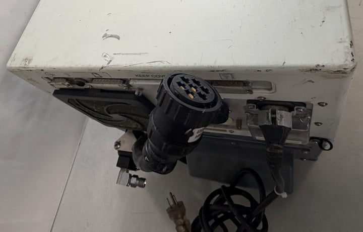 White rectangular medical device core unit with visible scuff marks, multiple power and data ports, and attached black cables on a plain surface, branded Philips Respironics.
