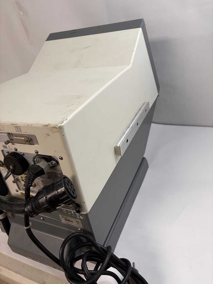 Side and rear view of a Philips Respironics Esprit V1000 core unit for parts and repair, featuring connected cables and worn white and gray casing on a white surface.