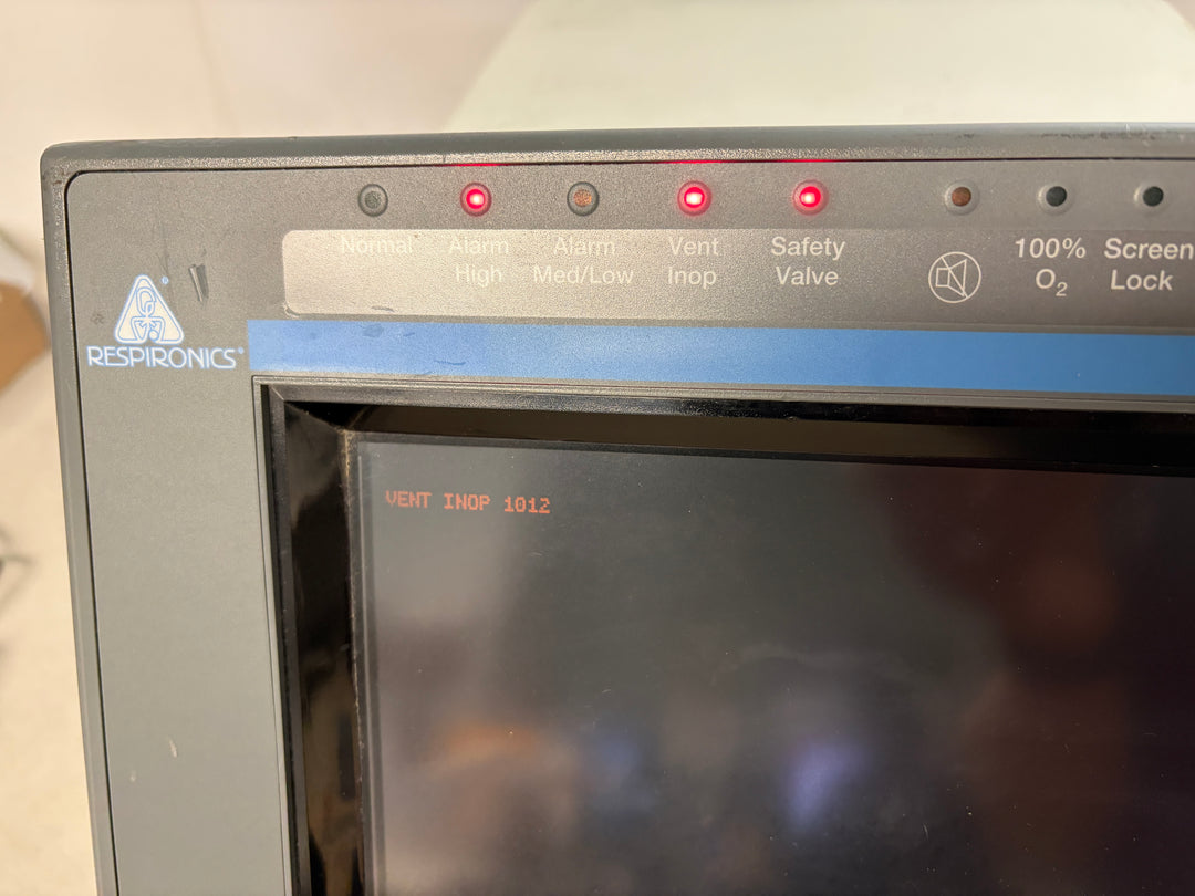 Close-up of a Philips Respironics medical device screen showing warning lights illuminated including Safety Valve and Vent Inop with a blank dark display background.