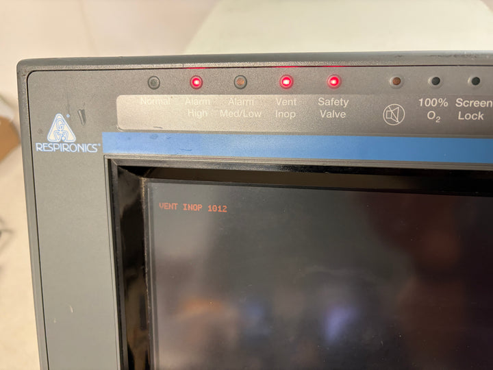 Close-up of a Philips Respironics medical device screen showing warning lights illuminated including Safety Valve and Vent Inop with a blank dark display background.