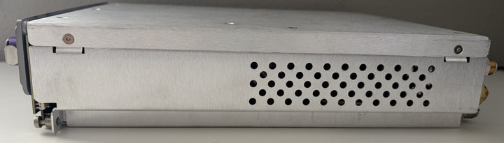 Rectangular metal device with a perforated cover on a gray background