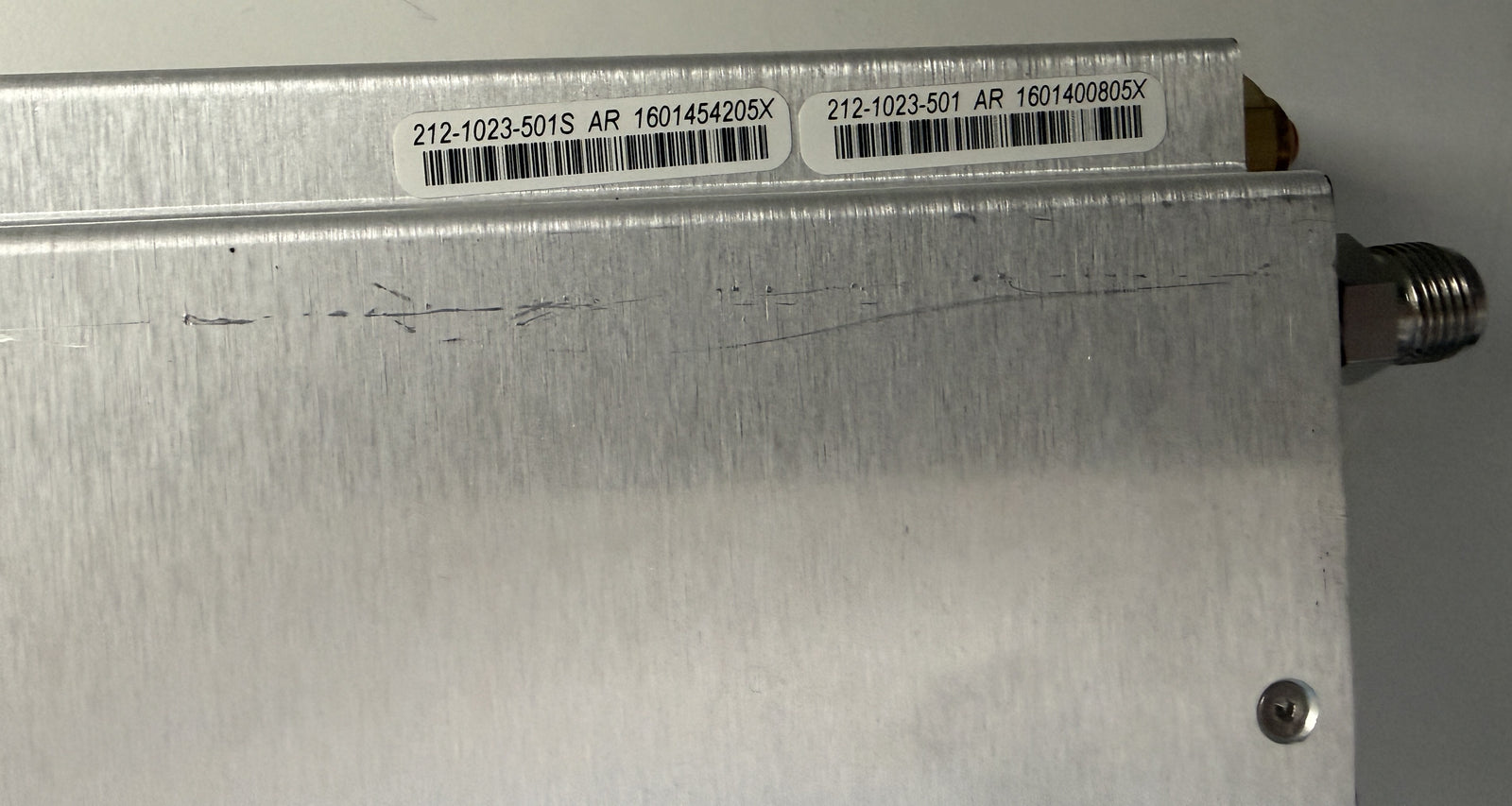 Metallic device with barcodes and text on a gray background