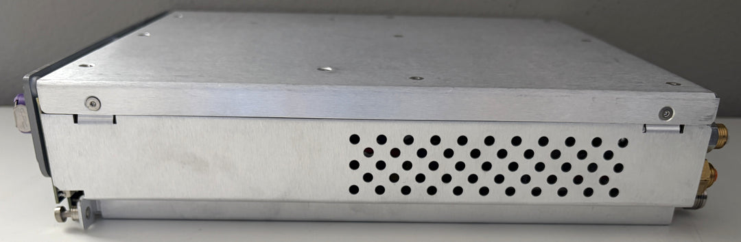 Metallic electronic device with perforated design on a gray background