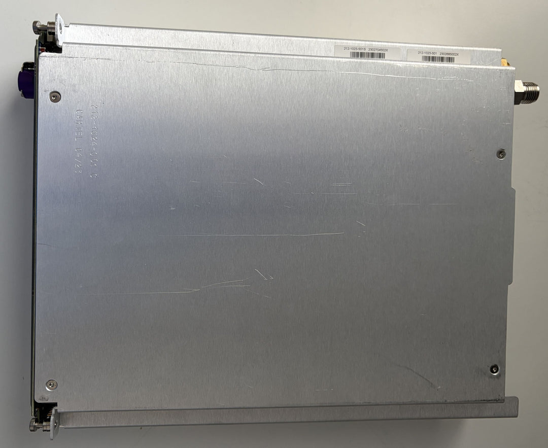 Metallic rectangular device with connectors on a gray background