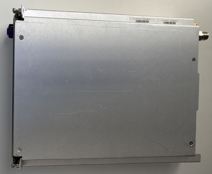 Metallic rectangular device with connectors on a gray background