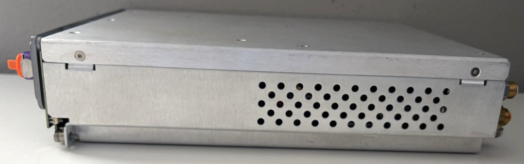 Metal electronic device with a perforated cover on a gray background