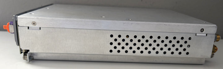 Metal electronic device with a perforated cover on a gray background