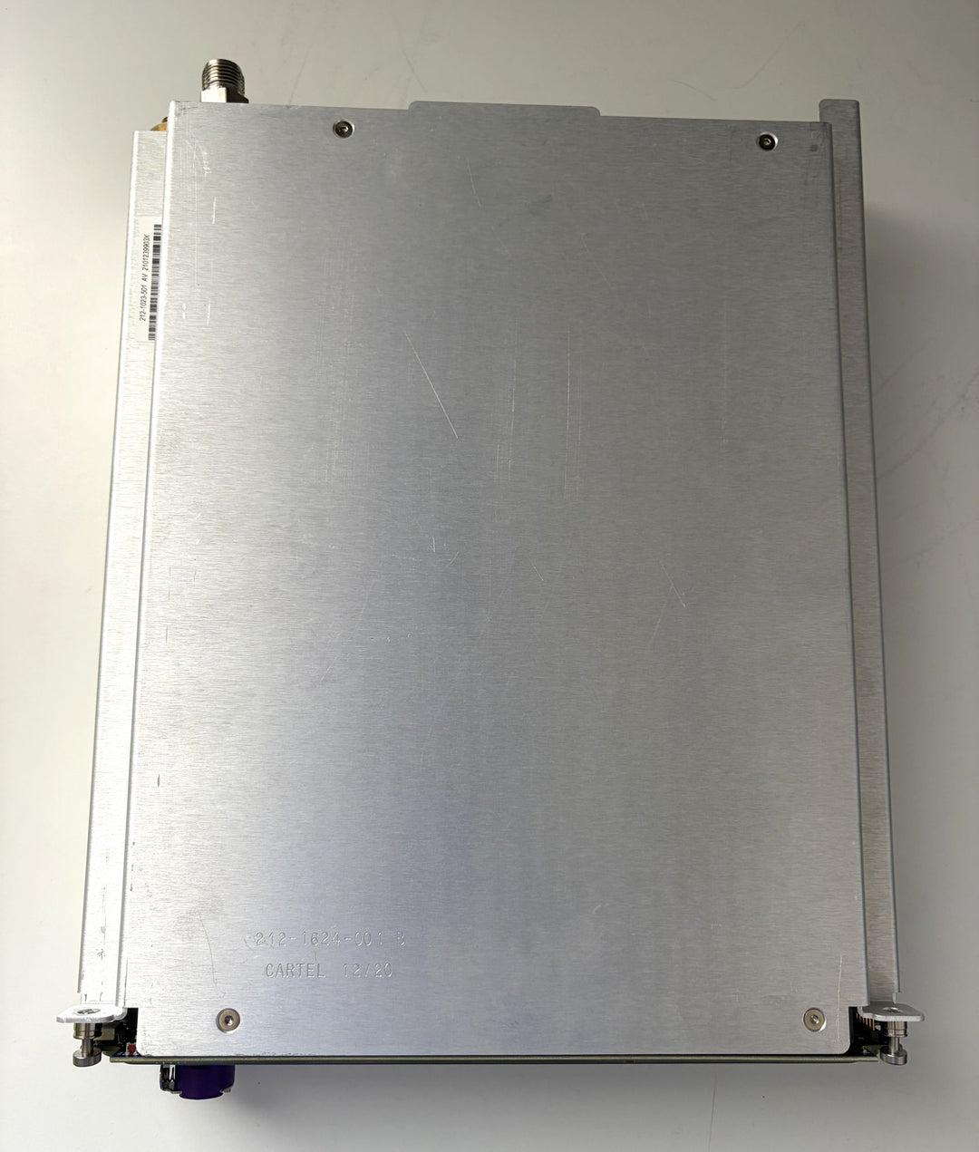 Metallic rectangular object with screws on a white background