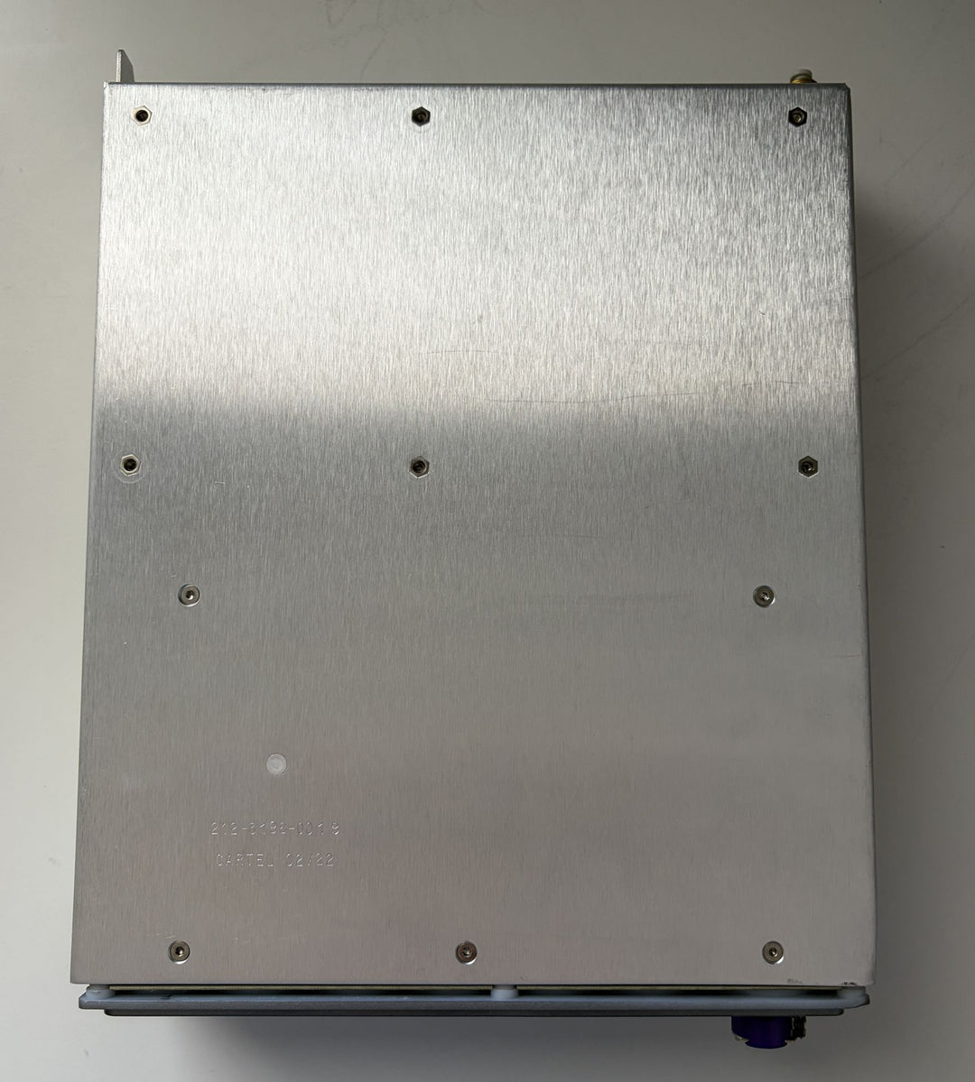 Metal box with screws on a plain background