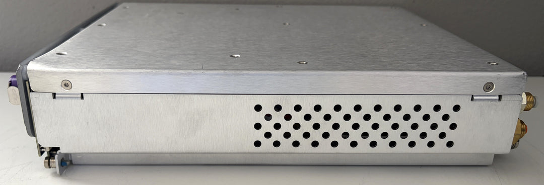 Metallic electronic device with a perforated design on a gray background