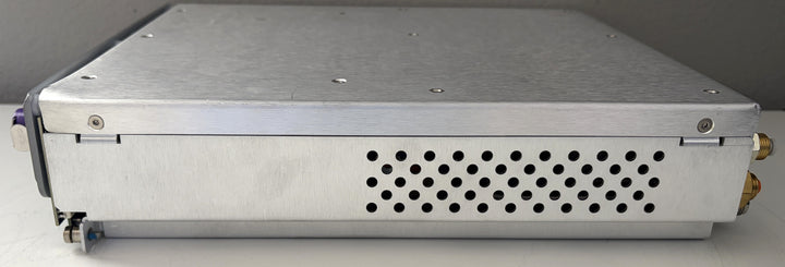Metallic electronic device with a perforated design on a gray background