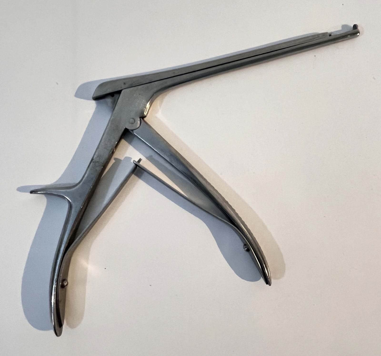 Close-up of Codman & Shurtleff Cervical Punch Forceps, precision surgical tool.