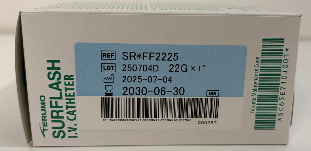 Close-up of a Terumo Surflash IV catheter box label showing product reference, lot number, size 22 gauge by 1 inch, and manufacturing codes on a white background.