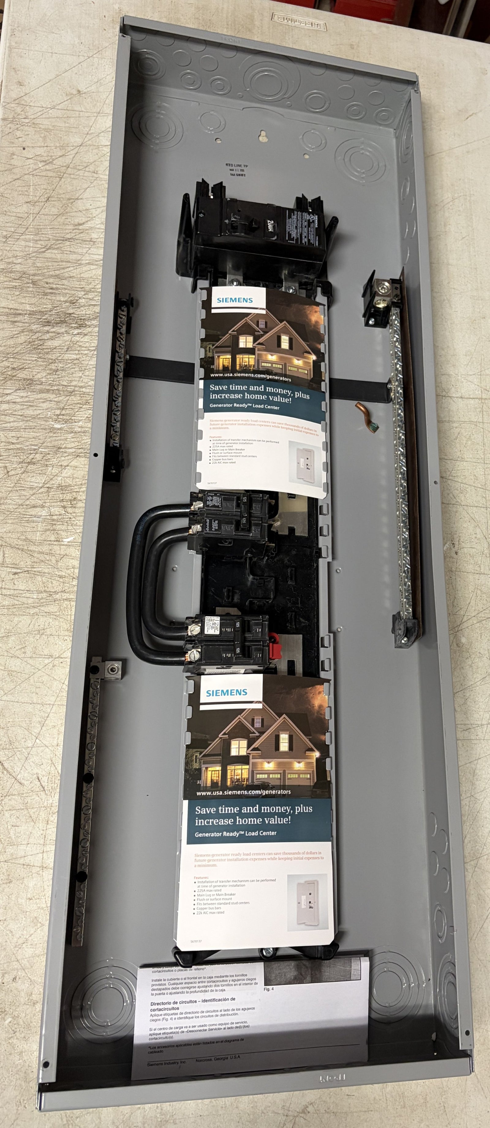 Open Siemens electrical load center panel showing internal circuit breakers, bus bars, and mounting hardware designed for residential electrical distribution.