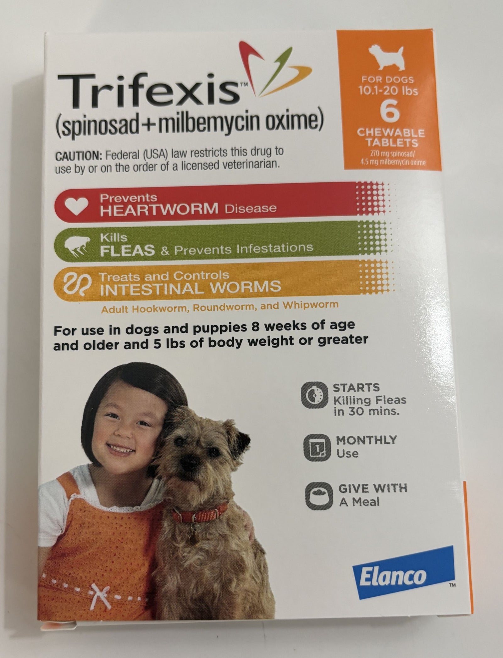 Box of Elanco Trifexis chewable tablets for dogs weighing 10 to 20 pounds, showing product benefits and usage instructions alongside a child and small dog.