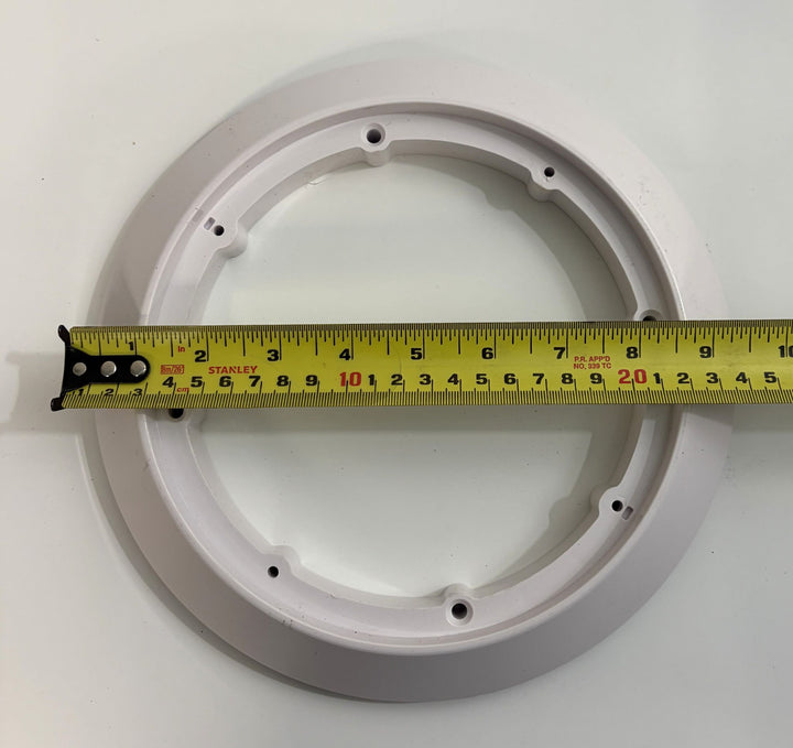 White circular pool suction outlet drain cover from AquaStar with mounting holes, shown alongside a tape measure indicating diameter for size reference.
