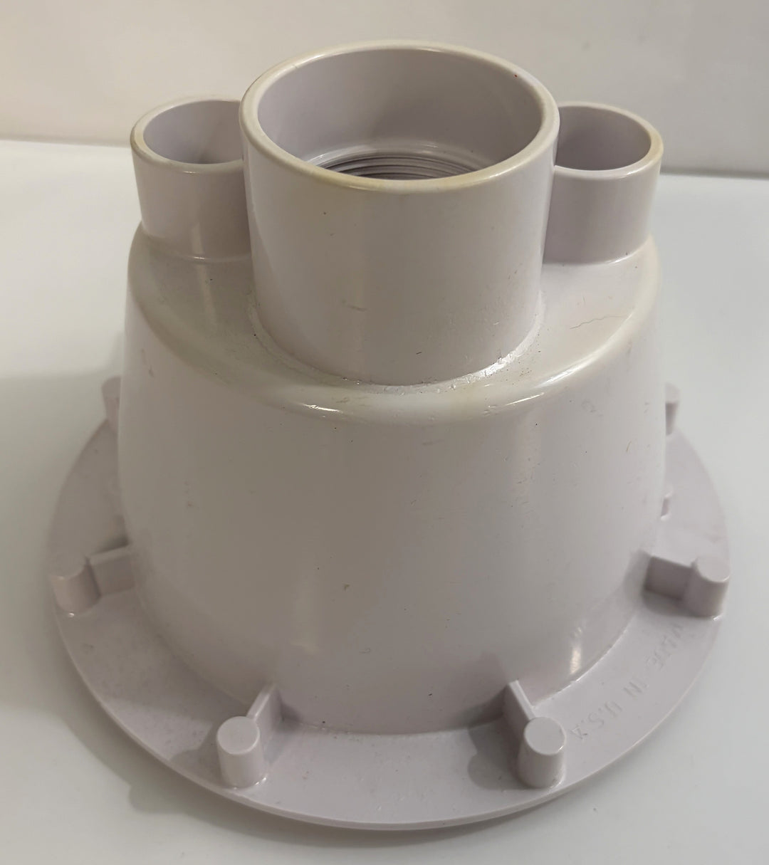 White plastic pool suction outlet drain cover component with multiple pipe connectors, designed by AquaStar for residential or commercial pool systems.