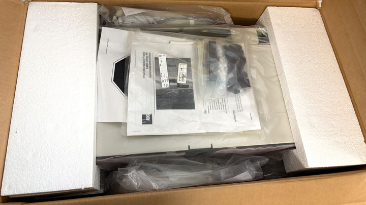 Open cardboard box with white foam inserts containing a new TE Connectivity optical distribution frame chassis block and accessory parts from PHENTERSALES, ready for industrial use.
