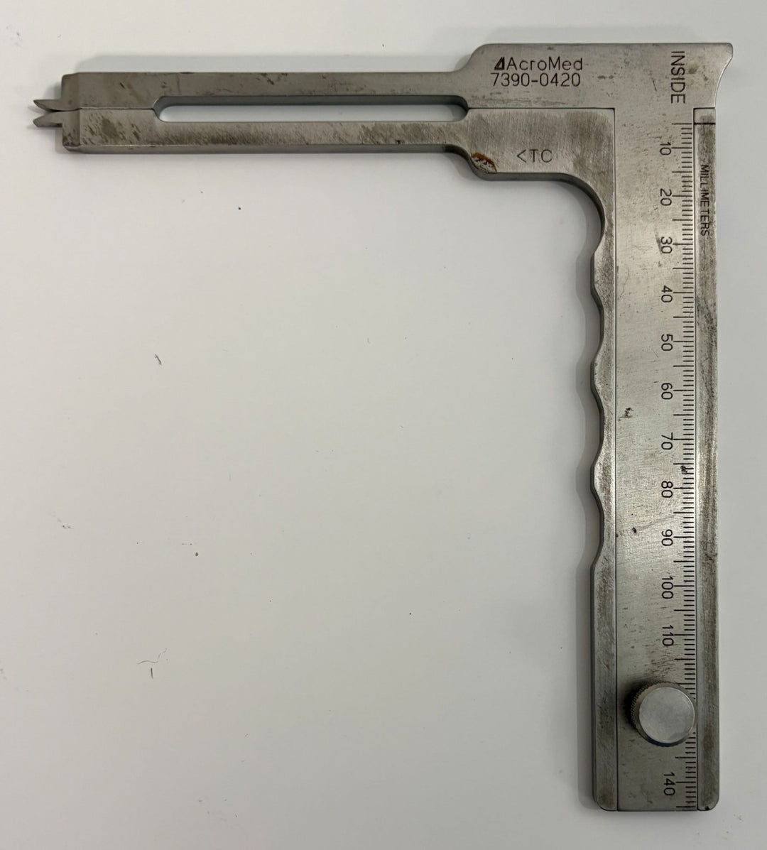 AcroMed stainless steel caliper spreader with engraved measurement scale and adjustable sliding arm, designed for precise pedicle distance measurement in medical applications.