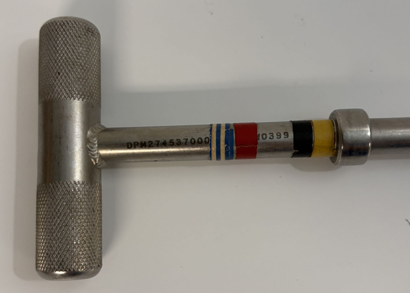 Close-up of a stainless steel T-handle hex driver with textured grip and colored bands on the shaft, used for medical or industrial applications by PHENTERSALES.