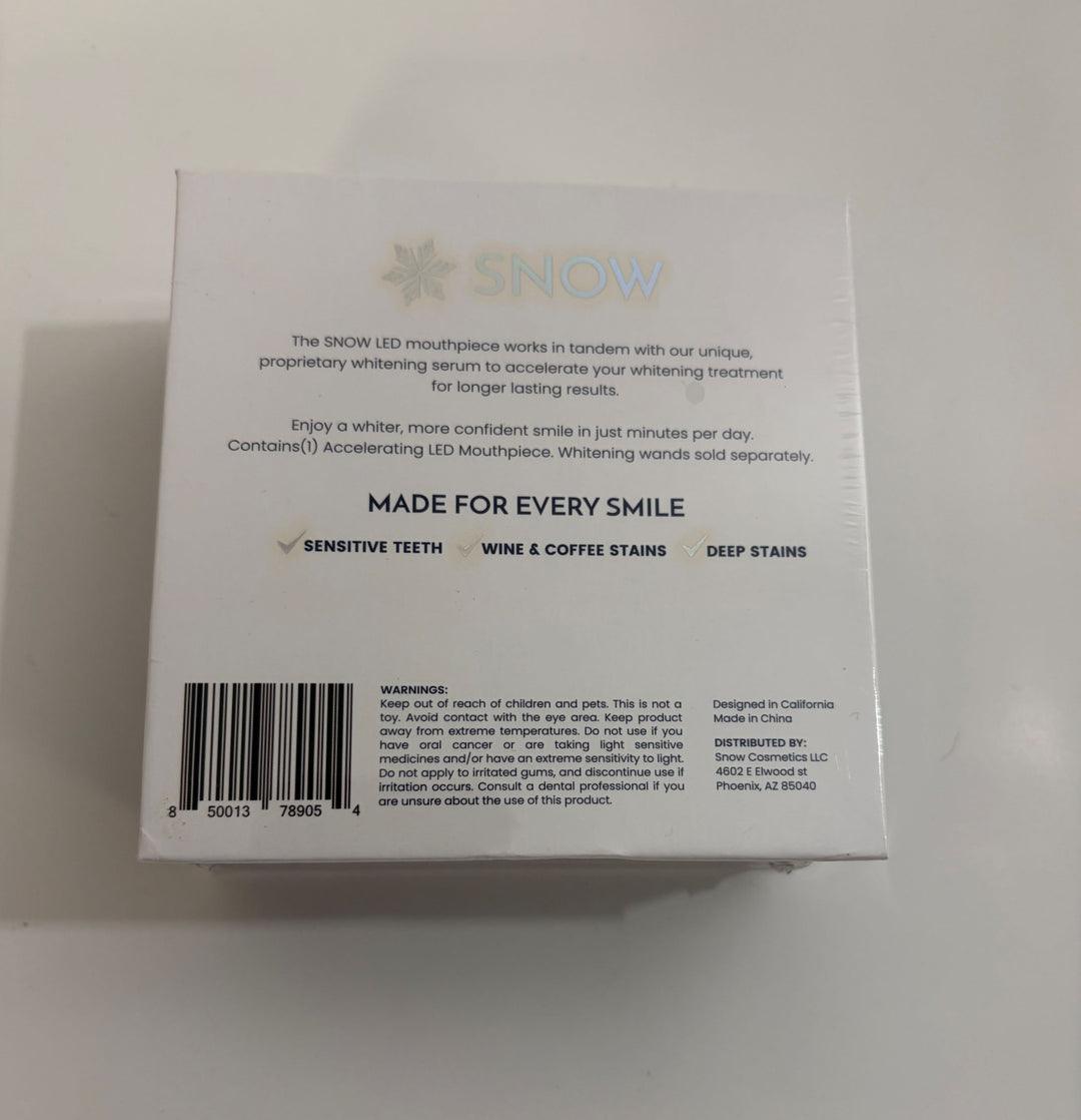 Back packaging of Snow LED teeth whitening device highlighting its serum compatibility, usage benefits for sensitive teeth and stain removal, with safety warnings and manufacturing details.